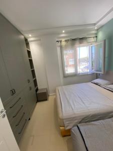 a small bedroom with two beds and a cabinet at Apartment Ferizaj in Velipojë