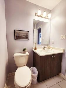 a bathroom with a toilet and a sink at Cozy 4 bedrooms home Milton in Milton