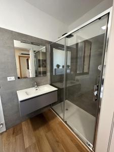 a bathroom with a sink and a shower at In Mezzo All'Aria Apartment in Mezzolara