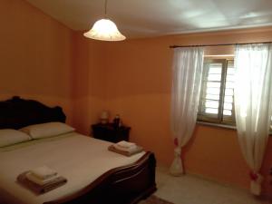 a bedroom with a bed and a window at VILLA CORTESE in SantʼEufemia Lamezia