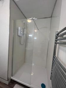 a shower with a glass door in a bathroom at SELF Check In Room Accommodation ONLY The Castle, Coldstream in Coldstream