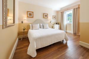 a bedroom with a large white bed and a window at Grand Hotel Bristol Spa Resort, by R Collection Hotels in Rapallo