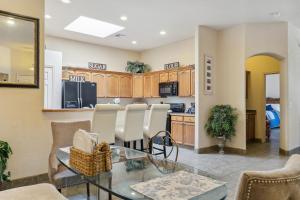 a kitchen and dining room with a glass table and chairs at Las Cruces Vacation Rental Near Trails and Golf! in Las Cruces