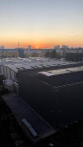 a large parking lot with a sunset in the background at * 3 Chambres - Haut de gamme - proche Paris * in Villejuif