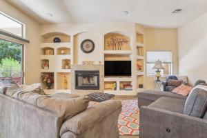 a living room with two couches and a fireplace at Las Cruces Vacation Rental Near Trails and Golf! in Las Cruces