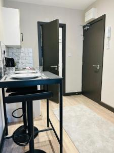 a kitchen with a blue table and a black door at Central Studio Like a Hotel Room in London