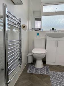 a bathroom with a white toilet and a sink at Home in Medway in Gillingham