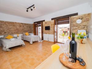 a living room with a table with a bottle of wine at Cubo's La Casa del Arco Room Granada in Cártama