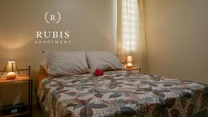 a bedroom with a bed with a red flower on it at Rubis Appartement - Magnifique F3 in Sainte-Anne