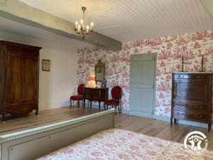 a bedroom with a bed and a table with chairs at Château de Gardès in Castin +12 photos