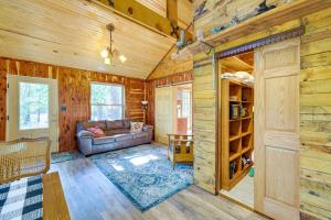 a living room with a couch and a table at Pet-Friendly Eureka Springs Rental with Private Deck in Eureka Springs