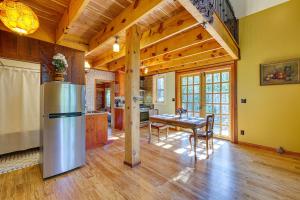 a kitchen and dining room with a refrigerator and a table at Pet-Friendly Eureka Springs Rental with Private Deck in Eureka Springs