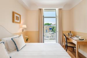 a hotel room with a bed and a desk and a window at Grand Hotel Bristol Spa Resort, by R Collection Hotels in Rapallo