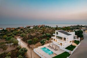 an aerial view of a house with a swimming pool at OPSIS Suites in Limenaria