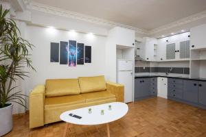 a living room with a couch and a table at Hestia Apartment! in Thessaloniki