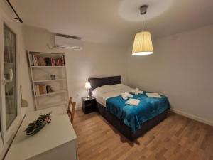 a bedroom with a bed and a table and a lamp at Villa Biondina in Senj