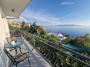 a balcony with a table and chairs and the ocean at Villa Biondina in Senj