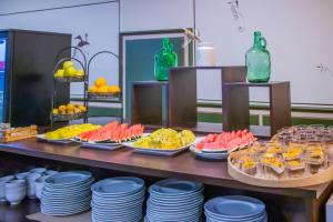 a buffet with several plates of food on a table at YIT Vereda Real in Valencina de la Concepción