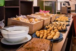 a buffet of pastries and other food on a table at YIT Vereda Real in Valencina de la Concepción