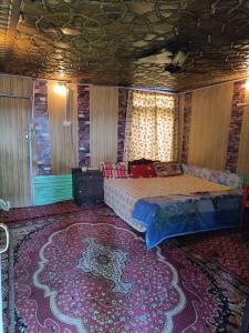 a bedroom with a bed and a large rug at Hotel Island in Srinagar