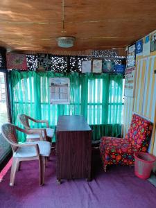 a room with chairs and a table in a train at Hotel Island in Srinagar