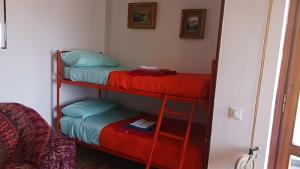 a room with three bunk beds in a room at Lake Maggiore 2 Minutes Apartment in Dormelletto