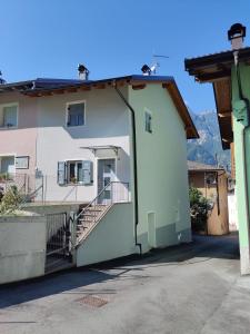 a white building with a staircase in front of it at Casa Venere in Ospedaletto