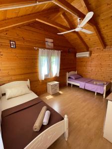 a room with two beds and a ceiling at Vila Livio - Guest house Rreshen Mirdite in Rrëshen