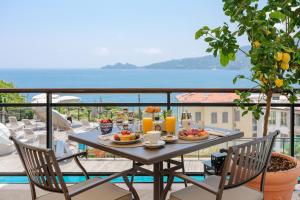 a table with food and drinks on a balcony at Grand Hotel Bristol Spa Resort, by R Collection Hotels in Rapallo