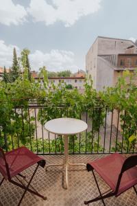 a table and two chairs on a balcony at Pension Bellevue in Munich