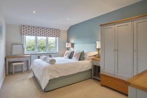 a small bedroom with a bed and a window at Meadowside in Saint Mawes