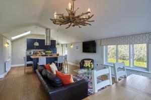 a living room with a couch and a table at Meadowside in Saint Mawes