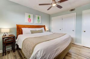 a bedroom with a bed and a ceiling fan at 0412 Memories Made At The Beach by Atlantic Towers in Carolina Beach