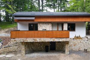 a house constructed out of a stone wall at Wellness chata Chalet de Glatz in Komorní Lhotka