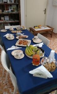 einen blauen Tisch mit Teller mit Lebensmitteln und Obst in der Unterkunft B&B Camera A Sud Tuglie Gallipoli in Tuglie