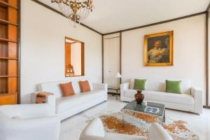 a living room with white furniture and a chandelier at Piazza Cavour Lake View - by MyHomeInComo in Como