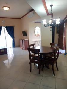 a dining room with a wooden table and chairs at Apartment Marbella Anyer in Serang