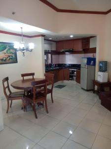 a kitchen with a table and chairs and a dining room at Apartment Marbella Anyer in Serang