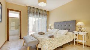 a bedroom with a large bed and a window at Men Men in Caleta De Fuste +33 photos