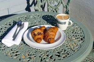 a plate of pastries and a cup of coffee on a table at Home in Longwell Green in Warmley