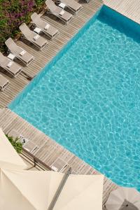 a swimming pool with chairs and a table and a pool at Grand Hotel Bristol Spa Resort, by R Collection Hotels in Rapallo