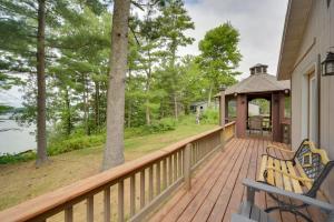 a deck with two benches and a gazebo at Lakefront Chetek Haven Dock, Screened Gazebo in Chetek