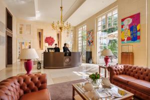 a lobby with two people at a reception desk at Grand Hotel Bristol Spa Resort, by R Collection Hotels in Rapallo