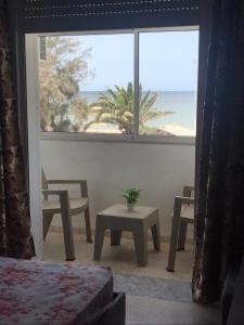 a room with a window with a table and chairs at Dream House in Houmt Souk