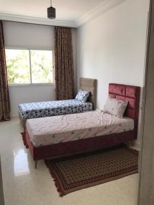 a bedroom with two beds and a window at Dream House in Houmt Souk