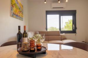 a table with wine bottles and glasses on it at Villa Bella Split - Podstrana in Podstrana