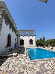 a house with a swimming pool next to a building at Vila Livio - Guest house Rreshen Mirdite in Rrëshen