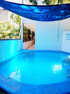 a swimming pool in a house with blue lighting at Hotel Zazil-Naj in Valladolid