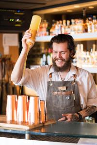 a man in an apron standing behind a counter at Fistral Beach Hotel and Spa - Adults Only in Newquay