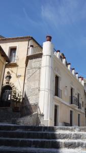 a building with stairs in front of a building at Palazzo Lupis B & B Grotteria Calabria Italia in Grotteria